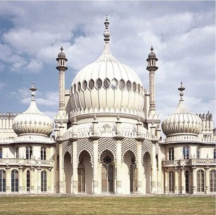 The exotic, Indo-Saracenic architecture of the Royal Pavilion in Brighton surrounded by its green gardens.