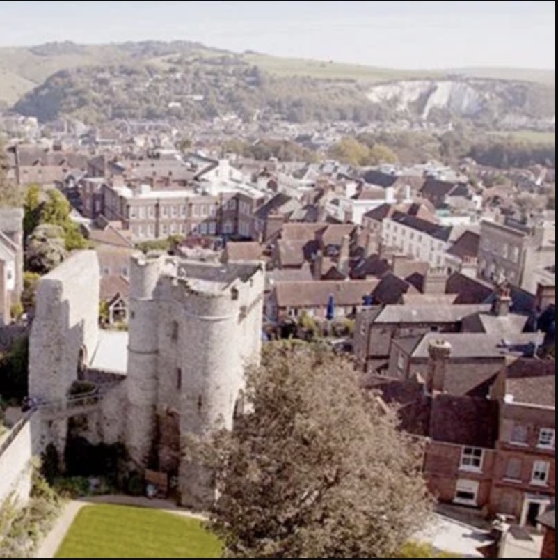The stone remains and gatehouse of the medieval Lewes Castle standing over the town.