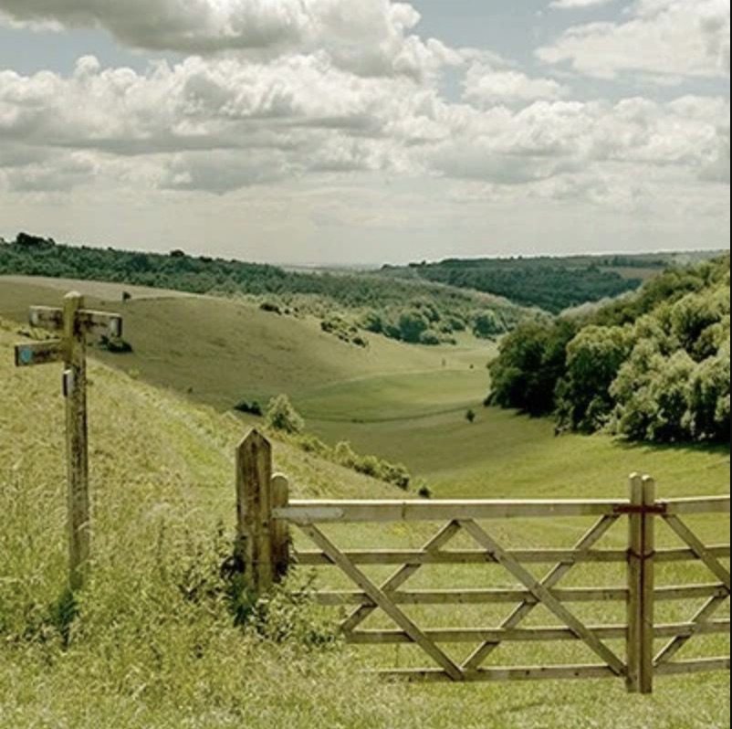 A panoramic high-angle view overlooking the Sussex Weald from the summit of Ditchling Beacon